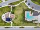 Aerial view of community featuring a playground, pool, parking, and green space with sidewalks between homes at 5134 Ballantrae Blvd, Land O Lakes, FL 34638