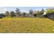 Wide backyard with grass and fencing, with a view of neighboring houses at 5134 Ballantrae Blvd, Land O Lakes, FL 34638