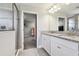 Modern bathroom featuring granite countertop, double vanity, and walk-in closet at 5134 Ballantrae Blvd, Land O Lakes, FL 34638