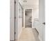 Hallway into ensuite bathroom featuring a tiled shower and large walk-in closet at 5134 Ballantrae Blvd, Land O Lakes, FL 34638