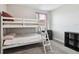 Cozy bedroom featuring a white bunk bed, soft carpeting, and a window with light-blocking curtains at 5134 Ballantrae Blvd, Land O Lakes, FL 34638