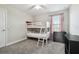 Cozy bedroom featuring a white bunk bed, soft carpet, and a bright window with pink curtains at 5134 Ballantrae Blvd, Land O Lakes, FL 34638