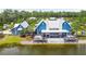 Spacious blue clubhouse with a waterfront view and large covered porch with outdoor seating areas at 5134 Ballantrae Blvd, Land O Lakes, FL 34638