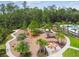 Community park with a play area, outdoor fireplace, walkways, and a seating area surrounded by trees at 5134 Ballantrae Blvd, Land O Lakes, FL 34638