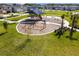 Aerial view of a well-maintained community playground with swings, slides, and ample green space at 5134 Ballantrae Blvd, Land O Lakes, FL 34638