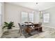 Dining area with wood table, decorative lighting, and windows allowing natural light at 5134 Ballantrae Blvd, Land O Lakes, FL 34638