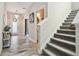 Inviting entryway showcasing wood-look flooring, a staircase, and a stylish front door with sidelights at 5134 Ballantrae Blvd, Land O Lakes, FL 34638