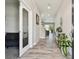 Inviting entryway with wood-look tile flooring, a sliding glass door and a decorative table with plant at 5134 Ballantrae Blvd, Land O Lakes, FL 34638