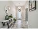 Bright entryway with modern lighting, wood-look tile, decorative mirror, and view of the door wreath at 5134 Ballantrae Blvd, Land O Lakes, FL 34638