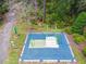 Outdoor fitness area features exercise equipment on a blue rubber surface amidst a backdrop of trees and natural landscaping at 5134 Ballantrae Blvd, Land O Lakes, FL 34638