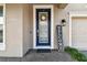 Charming front door with glass panel, welcome sign, wreath and stylish brick walkway at 5134 Ballantrae Blvd, Land O Lakes, FL 34638