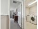 Hallway view into bedroom and laundry room with modern appliances at 5134 Ballantrae Blvd, Land O Lakes, FL 34638