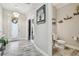 Hallway featuring wood-look tile flooring, a half bathroom, and modern art and lighting at 5134 Ballantrae Blvd, Land O Lakes, FL 34638