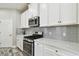 Bright kitchen with stainless steel appliances, quartz countertops, and gray subway tile backsplash at 5134 Ballantrae Blvd, Land O Lakes, FL 34638