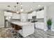 Kitchen featuring a large island, white cabinets, stainless steel appliances, and stylish bar stools at 5134 Ballantrae Blvd, Land O Lakes, FL 34638