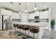 Bright kitchen with white cabinets, stainless steel appliances, quartz countertops, and a large island with seating at 5134 Ballantrae Blvd, Land O Lakes, FL 34638