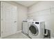 Modern laundry room with high-efficiency washer and dryer units at 5134 Ballantrae Blvd, Land O Lakes, FL 34638