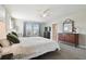 Serene main bedroom featuring a large window, dresser, and ceiling fan at 5134 Ballantrae Blvd, Land O Lakes, FL 34638