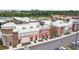 Aerial view showcasing a row of retail stores with pedestrian-friendly walkways and ample parking spaces at 5134 Ballantrae Blvd, Land O Lakes, FL 34638