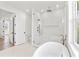 Bright bathroom with a glass enclosed shower, soaking tub, and modern fixtures at 531 Danube Ave, Tampa, FL 33606