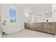 Bright bathroom featuring a soaking tub and elegant vanity with double sinks and modern fixtures at 531 Danube Ave, Tampa, FL 33606