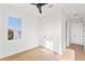 Bright bedroom with light wood floors, modern ceiling fan, and a view from the window at 531 Danube Ave, Tampa, FL 33606