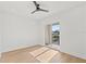 Bright bedroom with hardwood floors, ceiling fan, and sliding glass door to balcony at 531 Danube Ave, Tampa, FL 33606