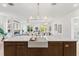 Bright kitchen featuring a large island with a farmhouse sink and modern fixtures at 531 Danube Ave, Tampa, FL 33606