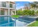 Beautiful backyard pool and spa surrounded by lush tropical landscaping at 531 Danube Ave, Tampa, FL 33606