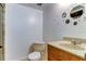 Simple bathroom featuring a toilet, vanity, and decorative mirrors at 5396 Gulf Blvd # 110, St Pete Beach, FL 33706