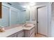 Bathroom with vanity, large mirror, and storage space at 5396 Gulf Blvd # 110, St Pete Beach, FL 33706