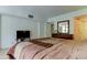 Bright bedroom featuring a TV, dresser with mirror, and comfortable bed at 5396 Gulf Blvd # 110, St Pete Beach, FL 33706