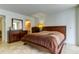 Cozy bedroom featuring a wooden bed frame, dresser, and neutral decor at 5396 Gulf Blvd # 110, St Pete Beach, FL 33706