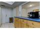 Kitchen area features wooden cabinets with blue countertop, stainless steel trash can and updated, stainless-steel appliances at 5396 Gulf Blvd # 110, St Pete Beach, FL 33706