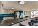 Modern kitchen featuring stainless steel appliances, a long bar and sleek black countertops at 5396 Gulf Blvd # 110, St Pete Beach, FL 33706