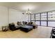 A relaxing living room featuring tile flooring, a comfy sectional sofa, and bright natural light from the window at 5396 Gulf Blvd # 110, St Pete Beach, FL 33706