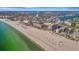 Expansive aerial view of a coastal community featuring a beach, ocean, and residential buildings on a sunny day at 5396 Gulf Blvd # 904, St Pete Beach, FL 33706