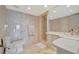 Elegant bathroom with marble walls, glass shower, and a large mirror above the vanity at 5396 Gulf Blvd # 904, St Pete Beach, FL 33706