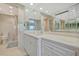 Bathroom featuring marble counters, a large mirror and generous cabinet space at 5396 Gulf Blvd # 904, St Pete Beach, FL 33706