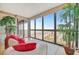 Comfortable living room with a large window displaying a beach view, complete with decorative plants at 5396 Gulf Blvd # 904, St Pete Beach, FL 33706