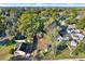 Aerial view of homes nestled among lush trees in a quiet neighborhood at 5518 11Th St, Zephyrhills, FL 33542