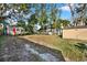 Expansive backyard with mature trees and a storage shed, offering plenty of space for outdoor activities at 5518 11Th St, Zephyrhills, FL 33542