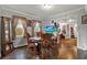 Dining area with hardwood floors, a cozy table, and lots of natural light at 5518 11Th St, Zephyrhills, FL 33542