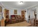 Cozy living room with wood floors, a brown reclining sofa, and decorative built-in shelving at 5518 11Th St, Zephyrhills, FL 33542