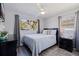 This bedroom features hardwood floors, natural light from two windows, and a ceiling fan at 5970 66Th N Ter, Pinellas Park, FL 33781