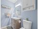 Charming bathroom features blue walls, new fixtures, and a rustic-look vanity at 5973 Terrace Park N Dr # 103, St Petersburg, FL 33709