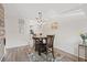 Cozy dining area with a wooden table set and wood-look flooring and view into kitchen area at 5973 Terrace Park N Dr # 103, St Petersburg, FL 33709