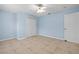 Inviting bedroom features neutral tile floors, light blue walls, and a ceiling fan at 6131 Tedder St, Port Charlotte, FL 33981