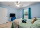 Comfortable bedroom features cool blue walls, tile floors, and a ceiling fan at 6131 Tedder St, Port Charlotte, FL 33981