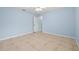 Spacious bedroom with tile floors, light blue walls, and a ceiling fan at 6131 Tedder St, Port Charlotte, FL 33981